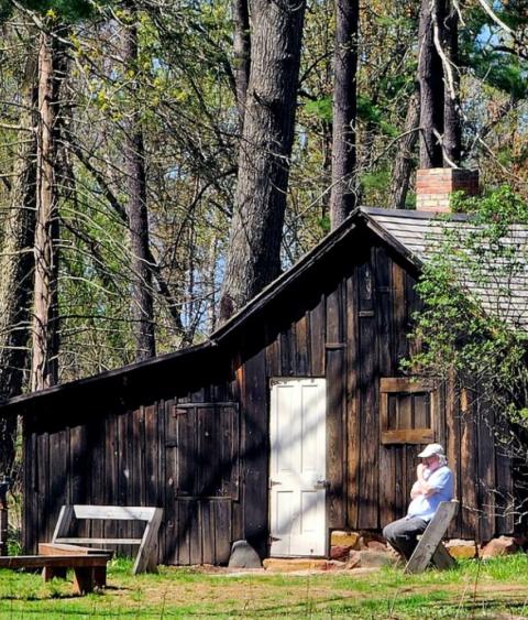 Mr. Murray Lloyd reflecting in front of the Aldo Leopold Shack