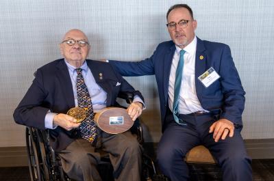 Lowell Baier receiving the 2025 Grinnell Award from Tony Wasley