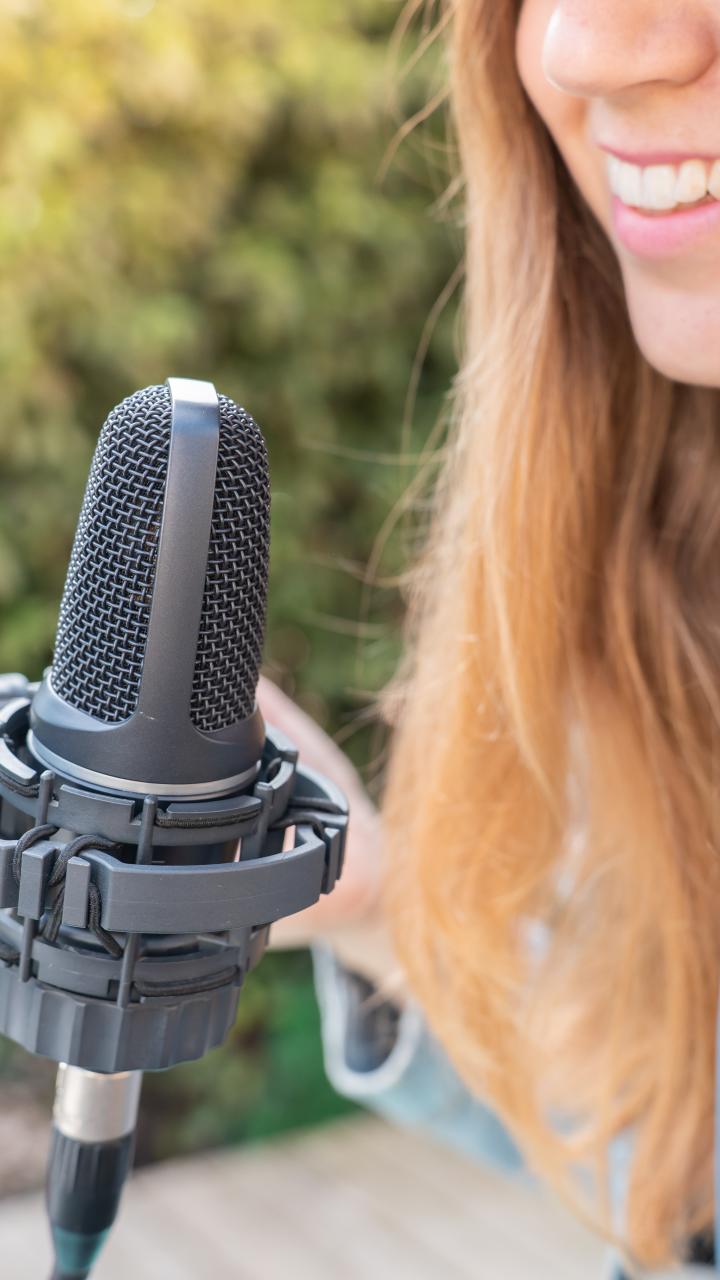 Closeup of a woman recording radio podcast