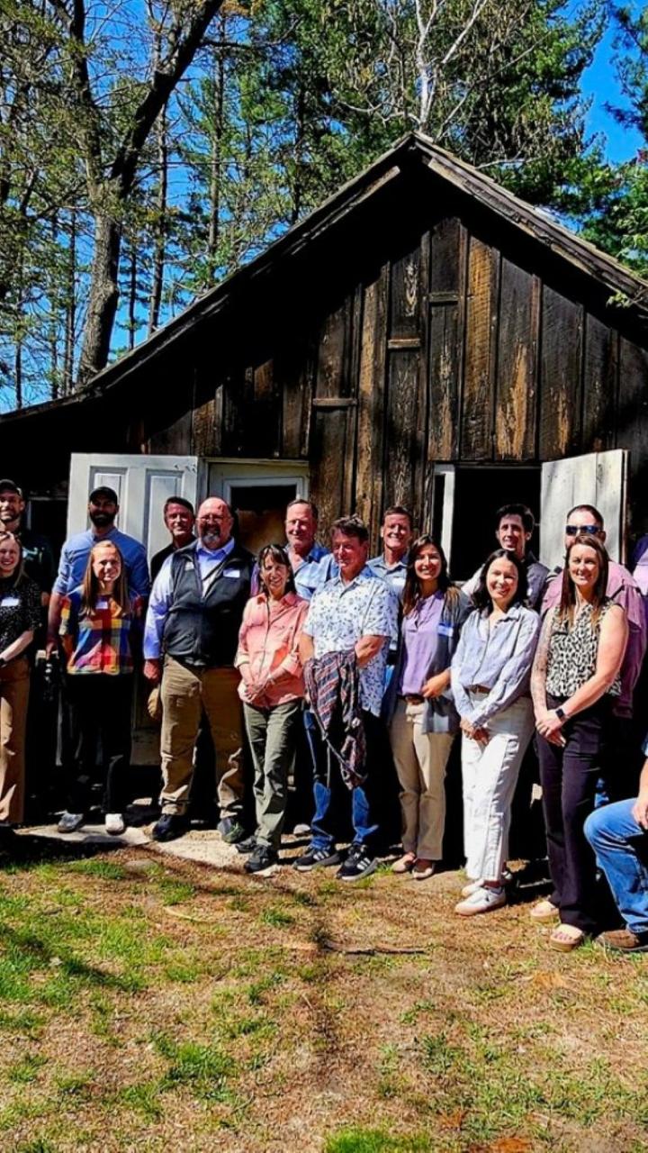 Wild Goose Chase participants group pictured in front of the Aldo Leopold Shack. 