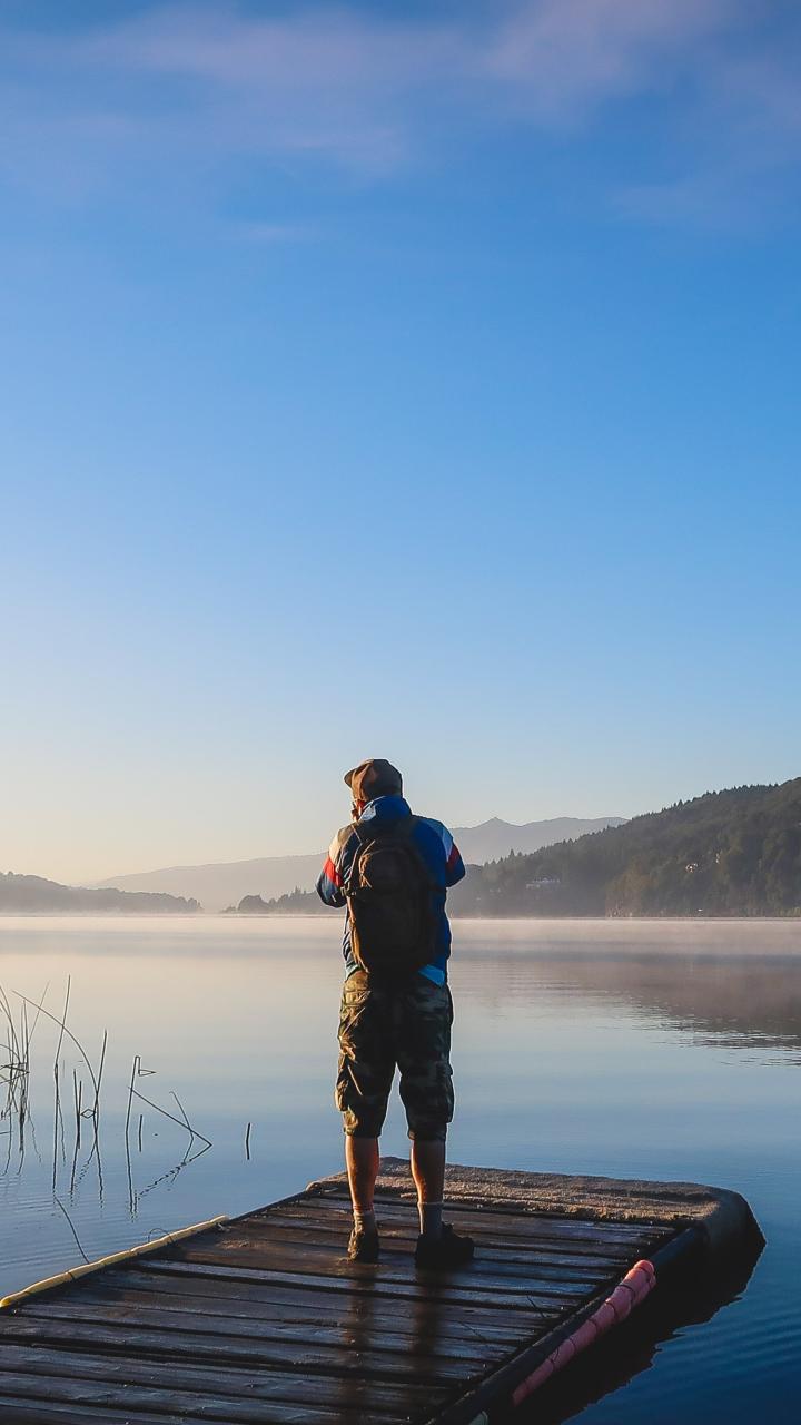 Lone Photographer Capturing Morning Mist on San Carlos de Bariloche Lake in Rio Negro
