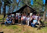 Wild Goose Chase participants group in front of the Aldo Leopold Shack.