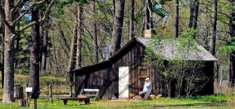 Mr. Murray Lloyd reflecting in front of the Aldo Leopold Shack