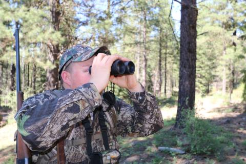 Hunter looking through binoculars